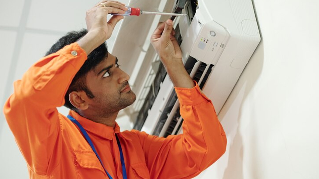 Technician Repairing AC